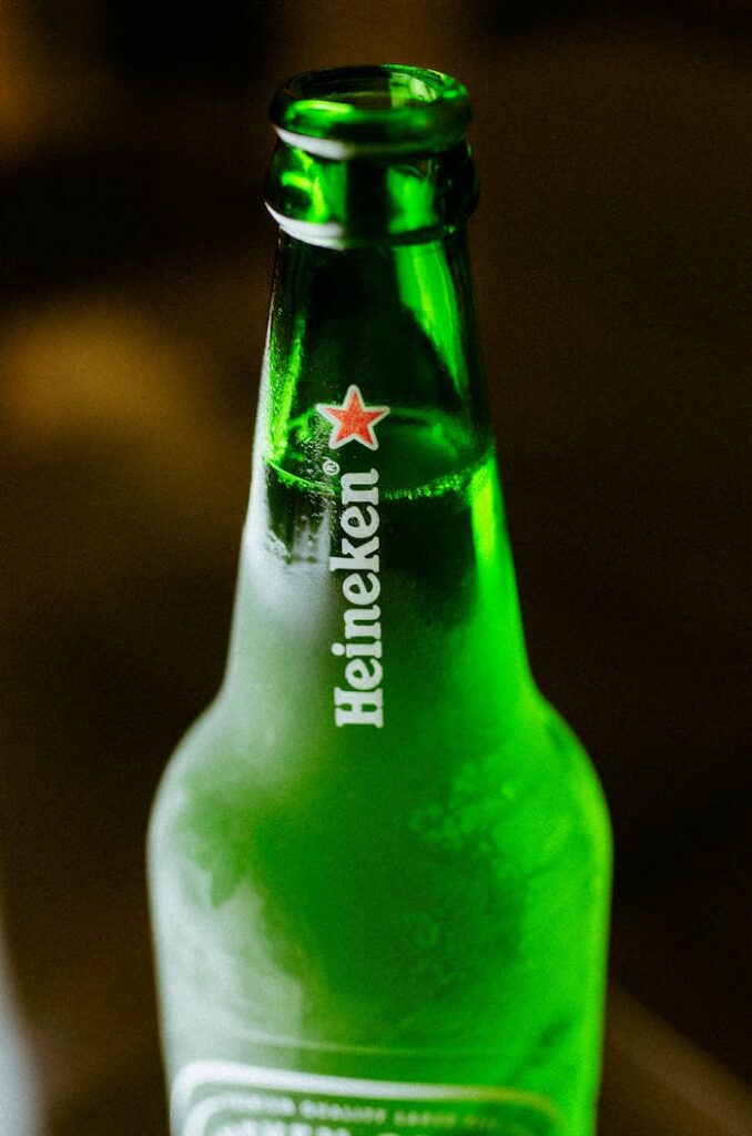 pexels-photo-4374009 Close-up of a frosted Heineken beer bottle with distinct branding, perfect for product promotions.